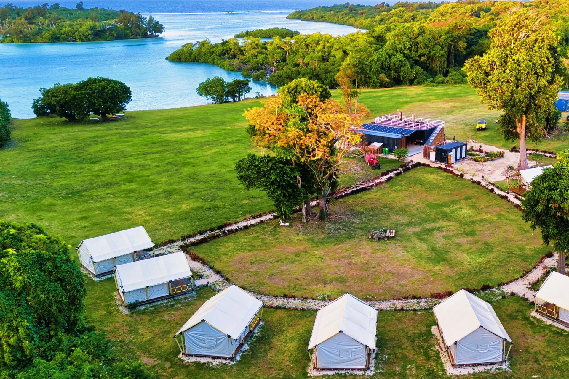 Aerial view of glamping tents with stunning ocean backdrop at Nawesa Resort Efate