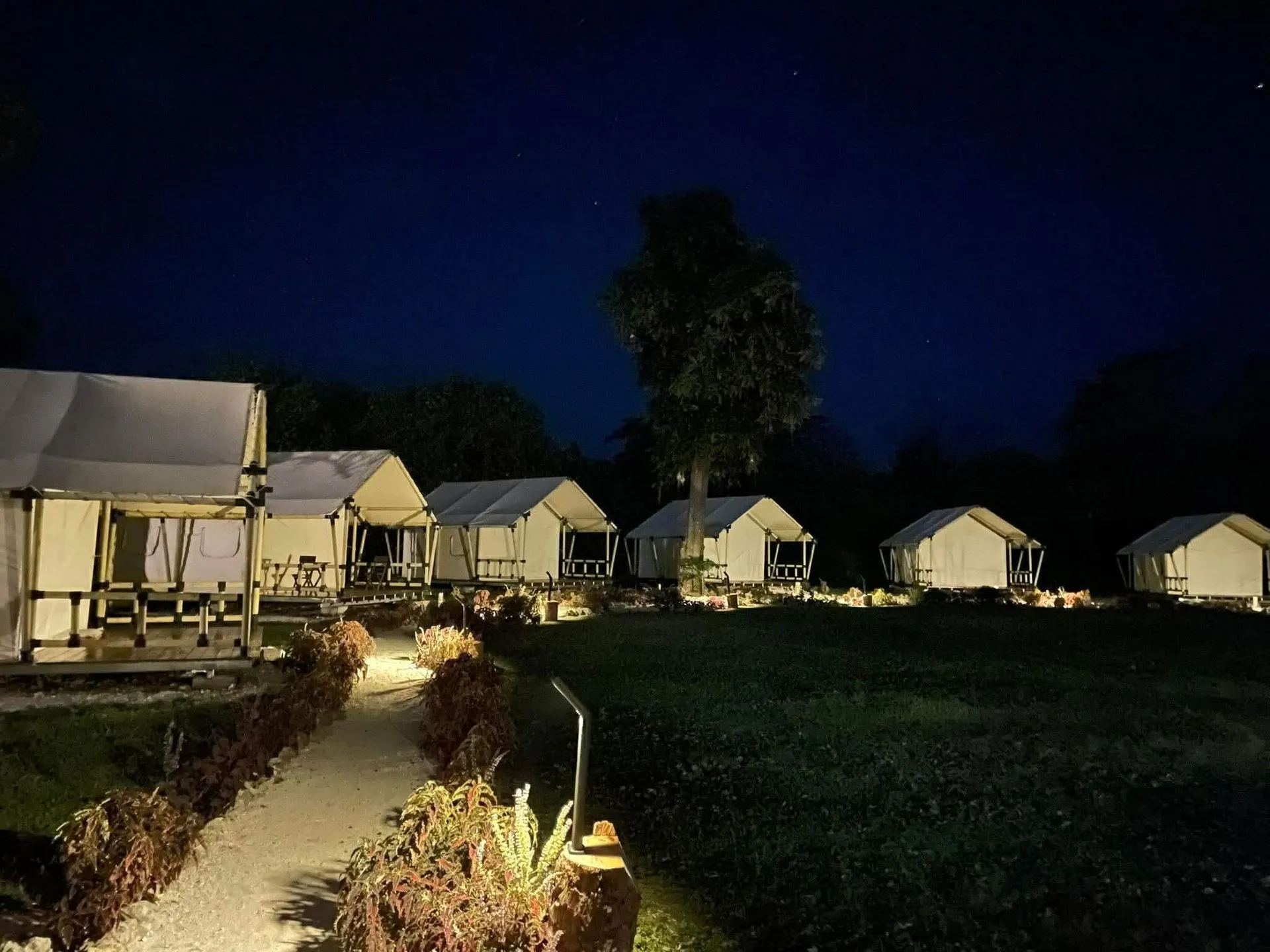 Cozy glamping tent illuminated at night at Nawesa beachfront resort Efate